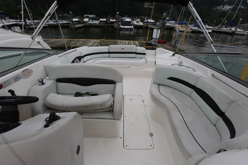 Slide: The Image of 2002 Chaparral 280 SSi boat interior with white seating at a marina. - 31