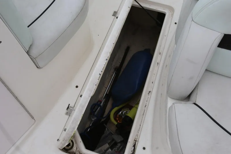 Slide: The Image of Storage compartment on a 2002 Chaparral 280 SSi boat, containing various items. - 34