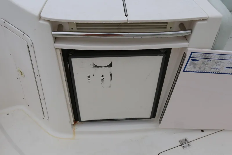 Slide: The Image of 2002 Chaparral 280 SSi boat interior with built-in mini fridge. - 40
