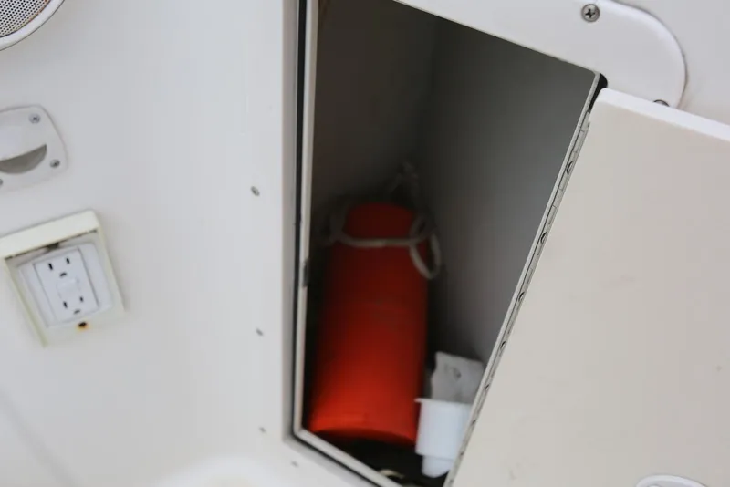 Slide: The Image of Open storage compartment on 2002 Chaparral 280 SSi boat with orange life jacket. - 45