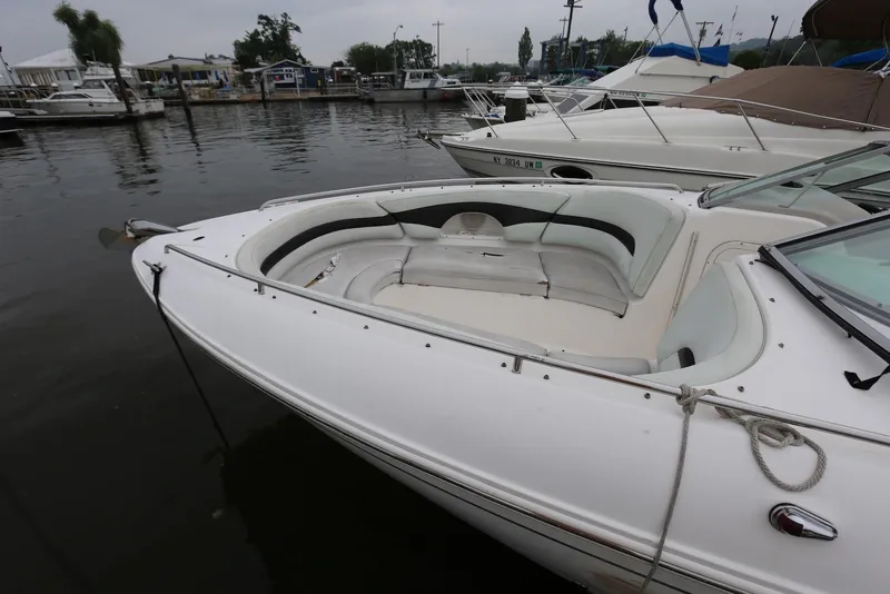 Slide: The Image of 2002 Chaparral 280 SSi boat docked at marina, featuring spacious seating area. - 5
