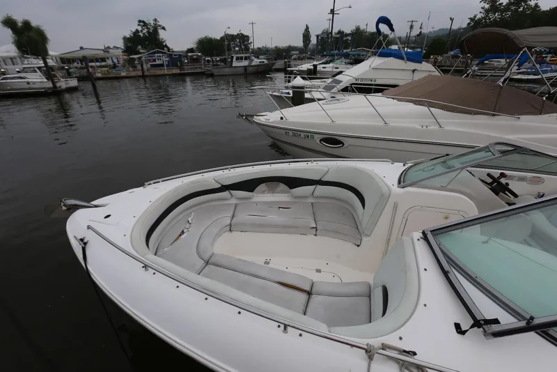 Slide: The Image of 2002 Chaparral 280 SSi boat docked in a marina, featuring spacious seating. - 6