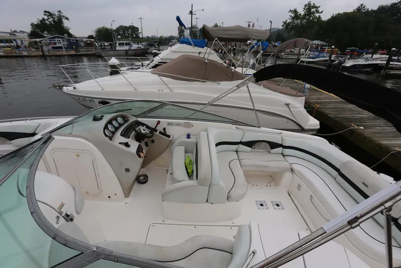 Slide: The Image of 2002 Chaparral 280 SSi boat docked, featuring spacious seating and sleek design. - 8