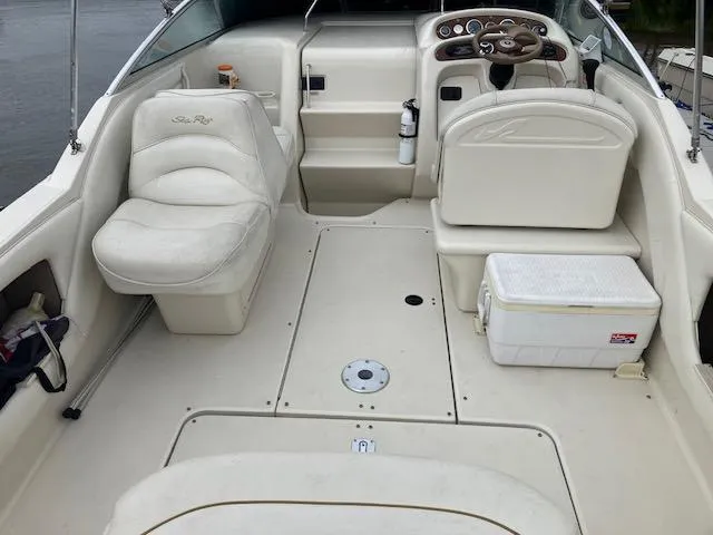 Slide: The Image of 2001 Sea Ray 245 Weekender boat interior with seating, steering console, and cooler. - 3
