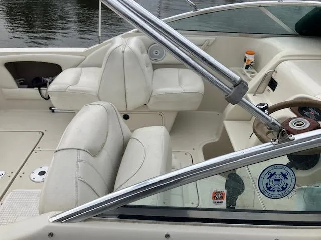 Slide: The Image of 2001 Sea Ray 245 Weekender boat interior with white leather seats and steering wheel. - 4