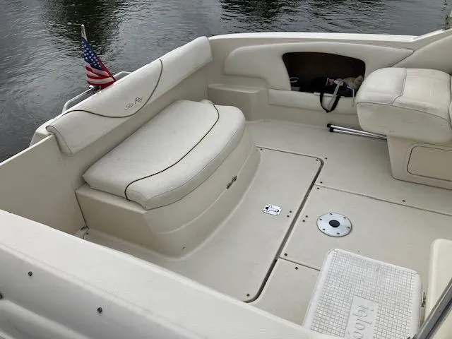 Slide: The Image of 2001 Sea Ray 245 Weekender boat interior with seating and American flag. - 5