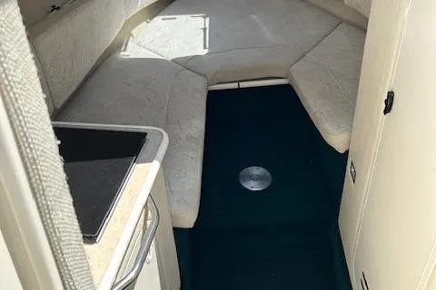 Slide: The Image of 2001 Sea Ray 245 Weekender cabin interior with seating and kitchenette. - 8