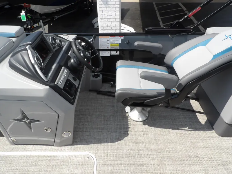 Slide: The Image of 2023 Berkshire 23RFX STS boat interior with steering console and captain's chair. - 4