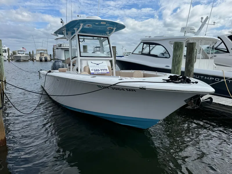 The Image of 2020 Sportsman Open 252 Center Console boat docked in marina. - 21