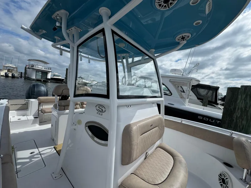 Slide: The Image of 2020 Sportsman Open 252 Center Console boat with blue T-top, docked at marina. - 24