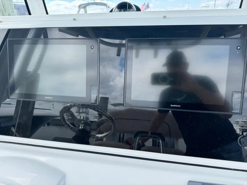 Slide: The Image of 2020 Sportsman Open 252 Center Console dashboard with dual Garmin displays. - 28