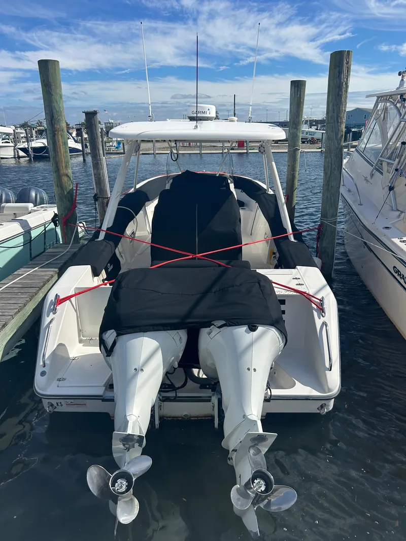Slide: The Image of 2016 Pursuit S 280 Sport boat docked with twin engines, covered and secured. - 10