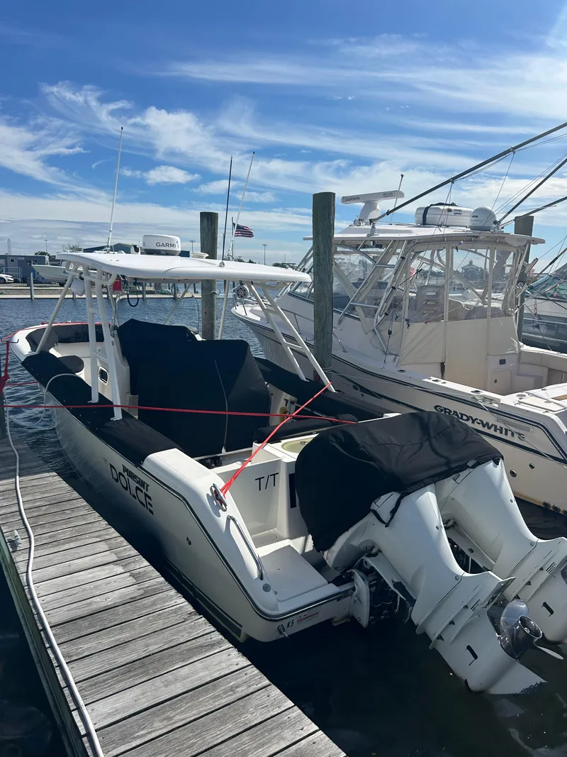 Slide: The Image of 2016 Pursuit S 280 Sport boat docked at marina under clear blue sky. - 11