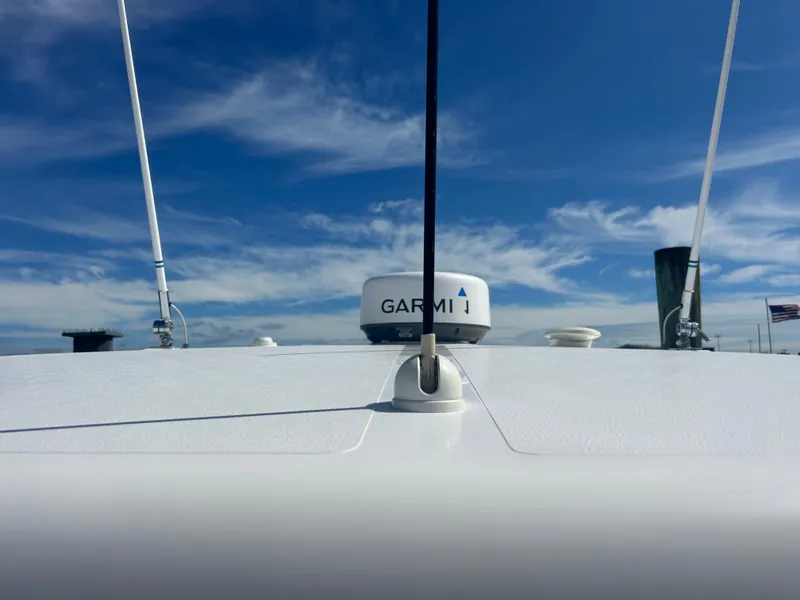 Slide: The Image of 2016 Pursuit S 280 Sport boat with Garmin radar against a blue sky. - 14