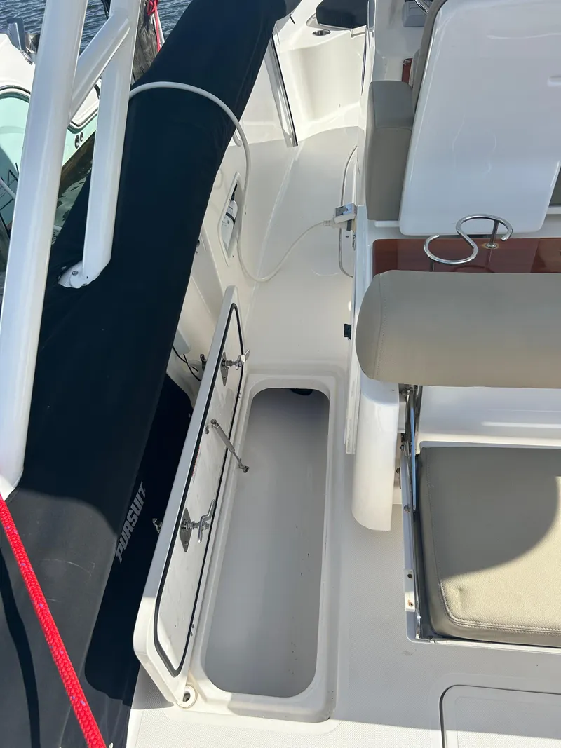 Slide: The Image of 2016 Pursuit S 280 Sport boat interior with seating and storage. - 21