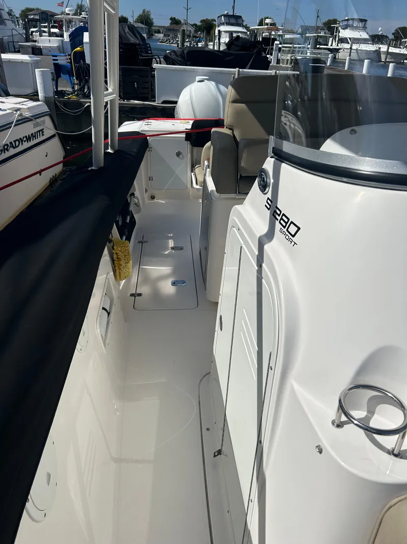 Slide: The Image of 2016 Pursuit S 280 Sport boat docked at marina, side view. - 28