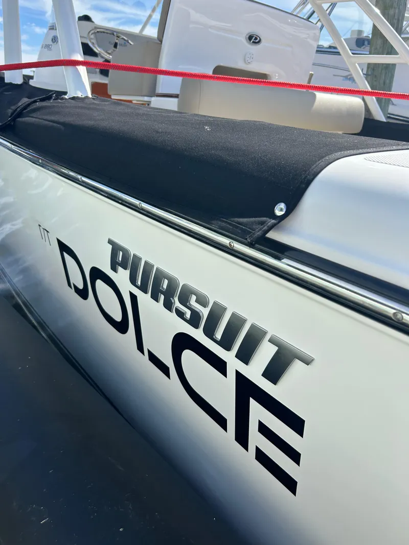 Slide: The Image of 2016 Pursuit S 280 Sport boat with "Dolce" branding, docked. - 36