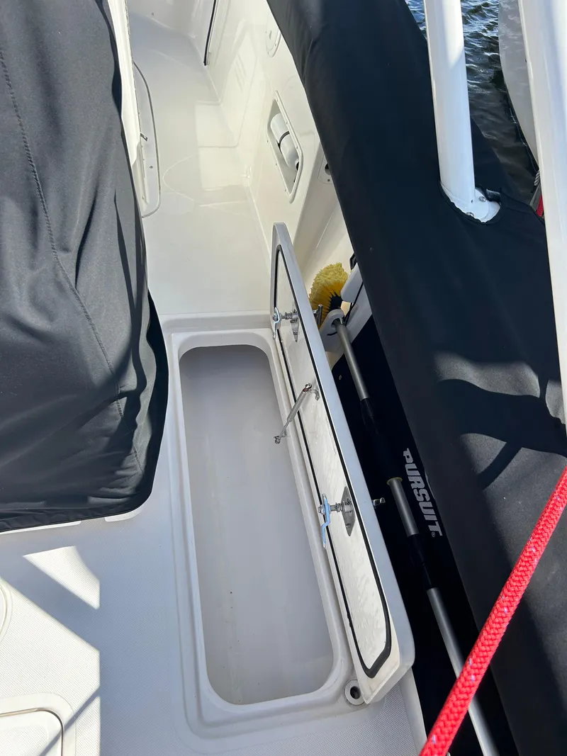 Slide: The Image of 2016 Pursuit S 280 Sport boat interior with open storage compartment. - 40