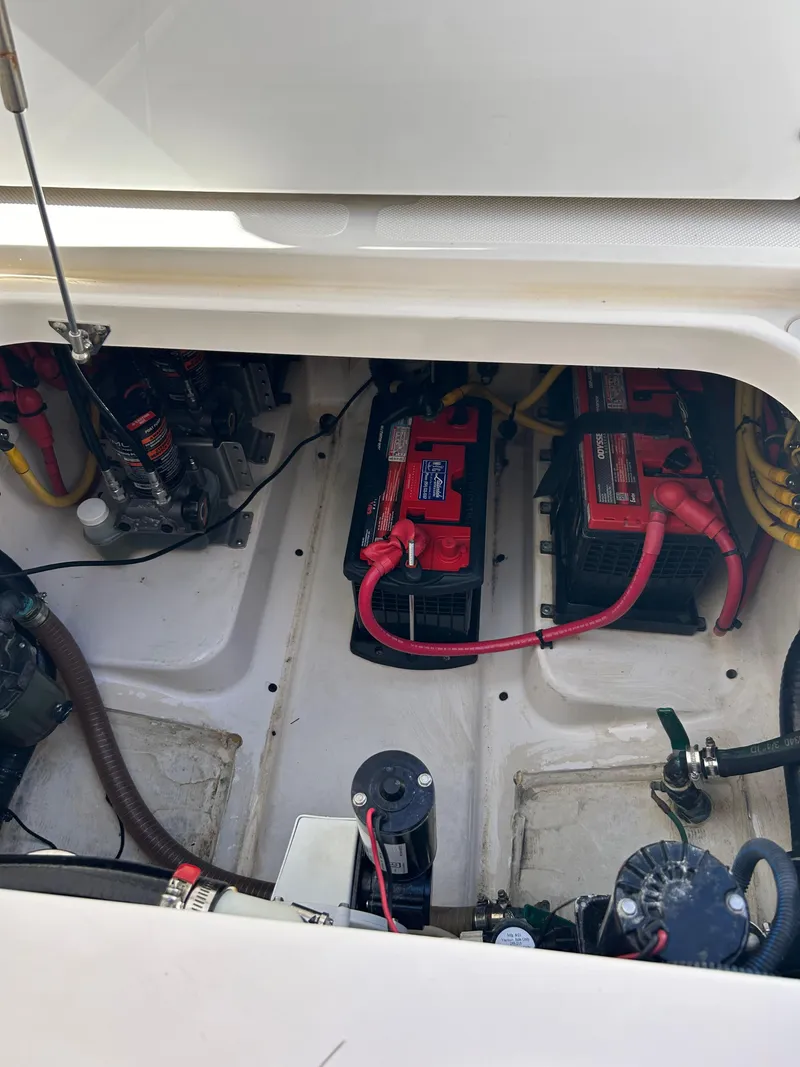 Slide: The Image of 2016 Pursuit S 280 Sport boat battery compartment with wiring and components. - 42