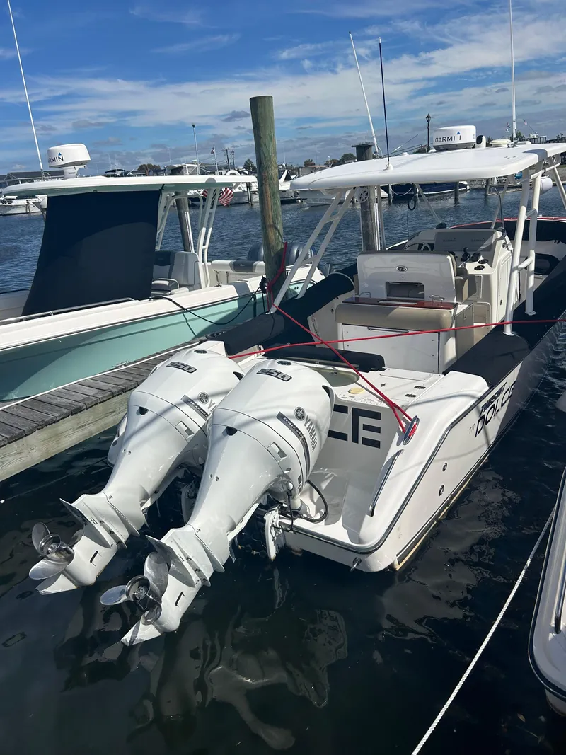 Slide: The Image of 2016 Pursuit S 280 Sport boat docked with twin outboard engines. - 9