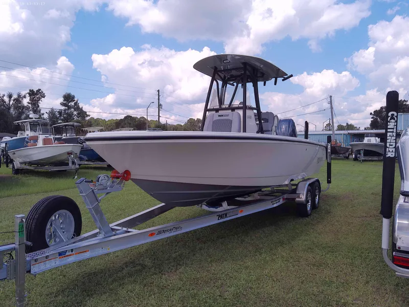 The Image of 2025 Pathfinder 2400 Open boat on trailer, parked on grass under a cloudy sky. - 1