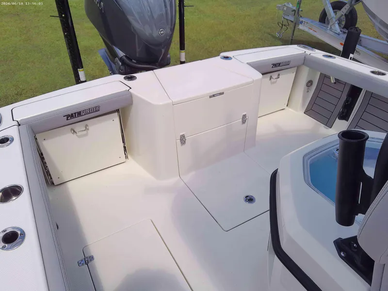 Slide: The Image of 2025 Pathfinder 2400 Open boat interior with storage compartments and motor. - 10