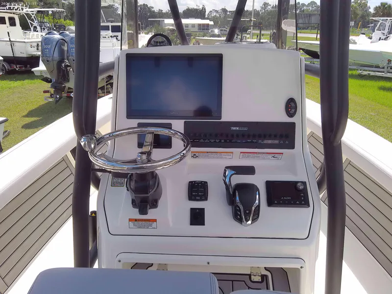 Slide: The Image of 2025 Pathfinder 2400 Open boat console with steering wheel and navigation screen. - 12