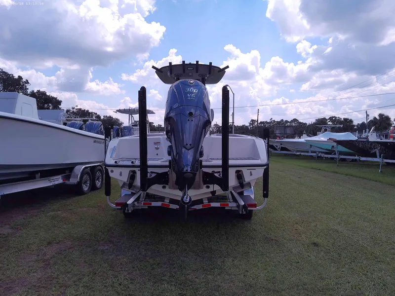 Slide: The Image of 2025 Pathfinder 2400 Open boat on trailer, parked on grass under cloudy sky. - 3