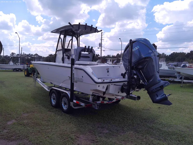Slide: The Image of 2025 Pathfinder 2400 Open boat on trailer, parked on grass under cloudy sky. - 4