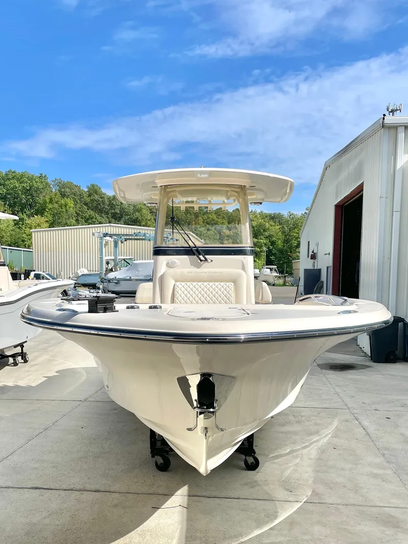 Slide: The Image of 2025 Grady-White 281 Coastal Explorer boat, docked outdoors under a clear blue sky. - 3