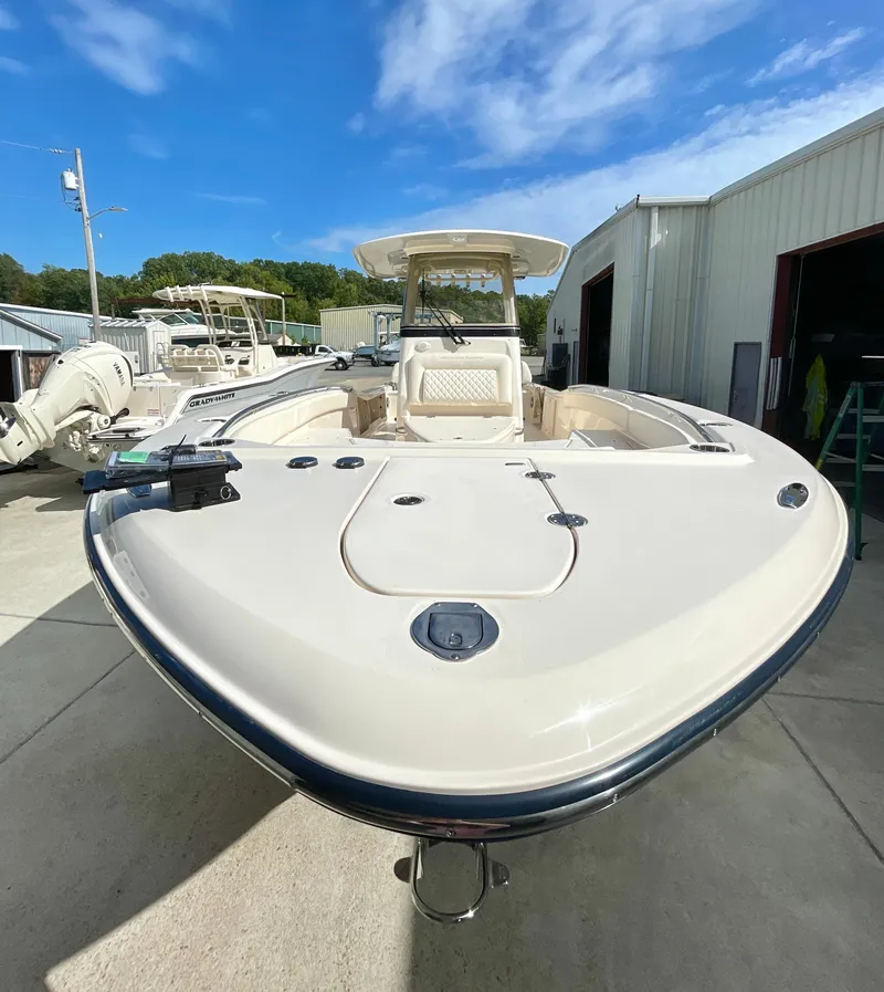 Slide: The Image of 2025 Grady-White 281 Coastal Explorer boat, docked outdoors under a clear blue sky. - 4