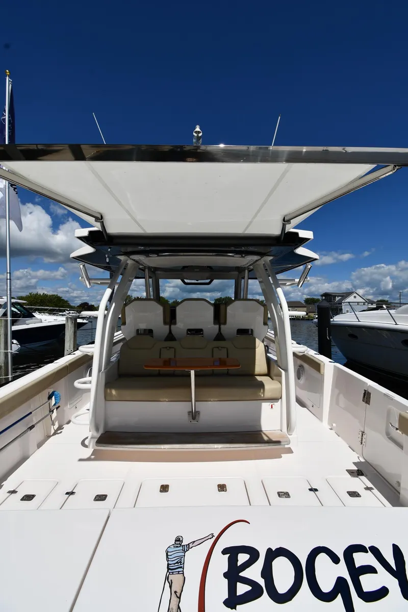 Slide: The Image of 2019 Pursuit S 408 Sport boat docked under clear blue sky. - 11