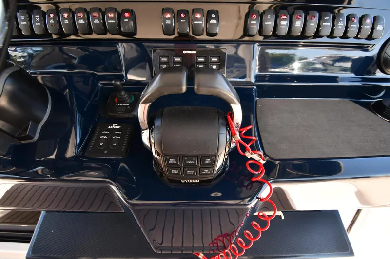 Slide: The Image of Control panel of a 2019 Pursuit S 408 Sport boat with switches and throttle. - 15