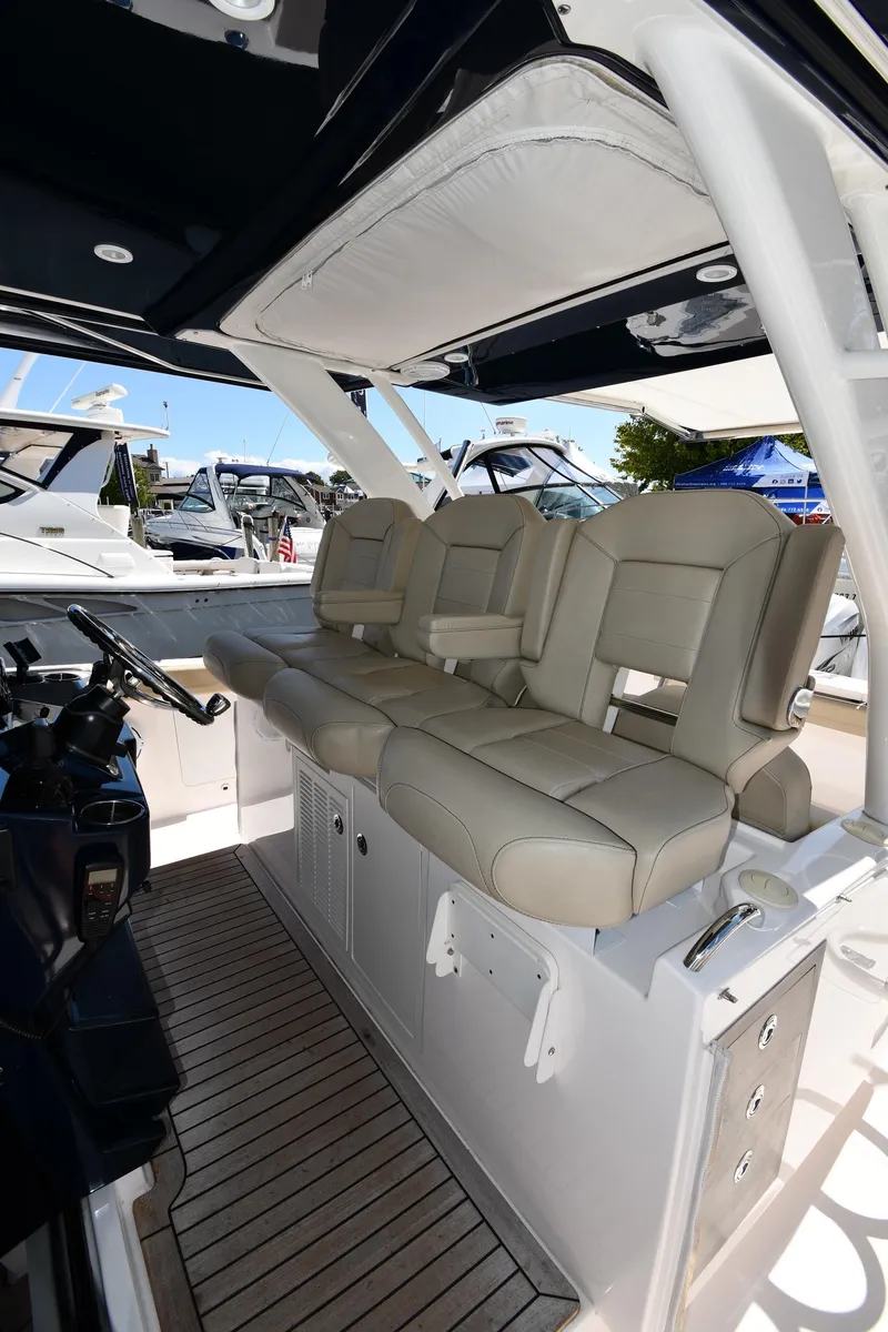 Slide: The Image of 2019 Pursuit S 408 Sport boat interior with beige seating and sleek design. - 19