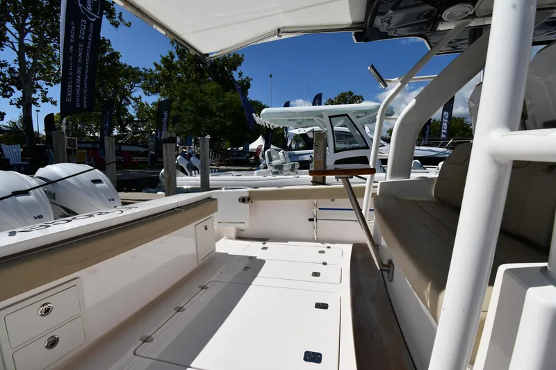 Slide: The Image of 2019 Pursuit S 408 Sport boat interior with seating and storage, displayed outdoors. - 24