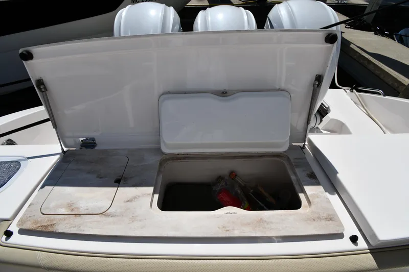 Slide: The Image of 2019 Pursuit S 408 Sport boat storage compartment with open lid. - 28