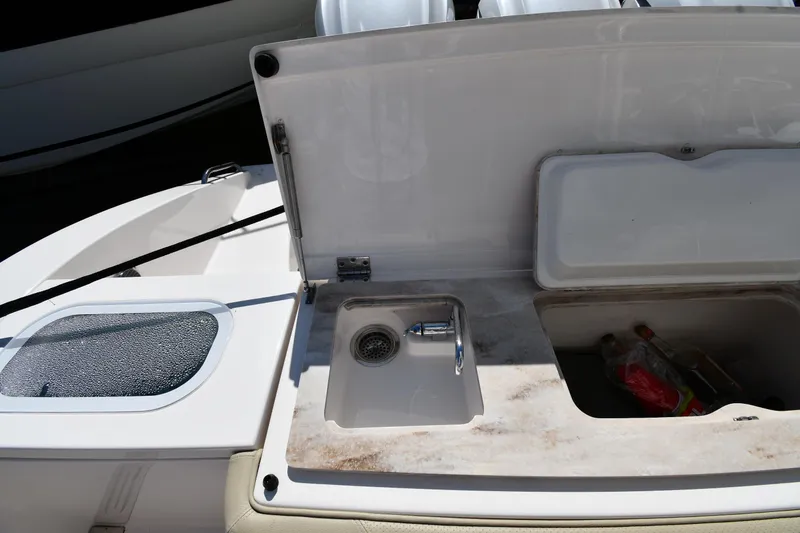 Slide: The Image of 2019 Pursuit S 408 Sport boat sink and storage compartment. - 29