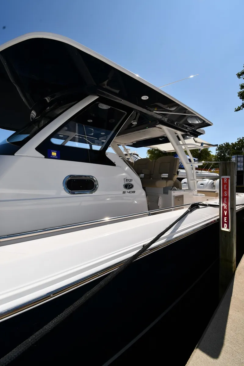 Slide: The Image of 2019 Pursuit S 408 Sport boat docked under clear blue sky. - 3