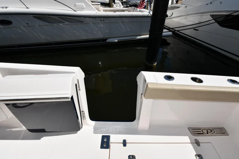 Slide: The Image of 2019 Pursuit S 408 Sport boat deck with storage compartments and rod holders. - 35