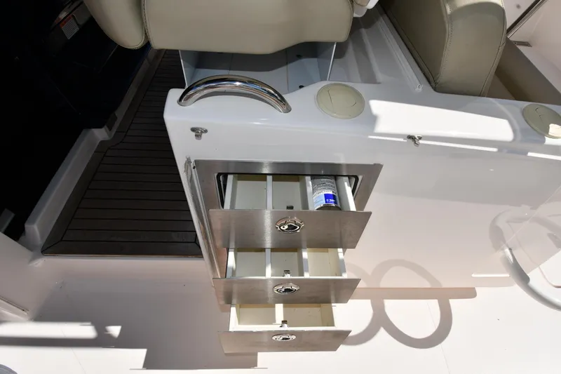 Slide: The Image of 2019 Pursuit S 408 Sport boat interior with open storage drawers. - 36
