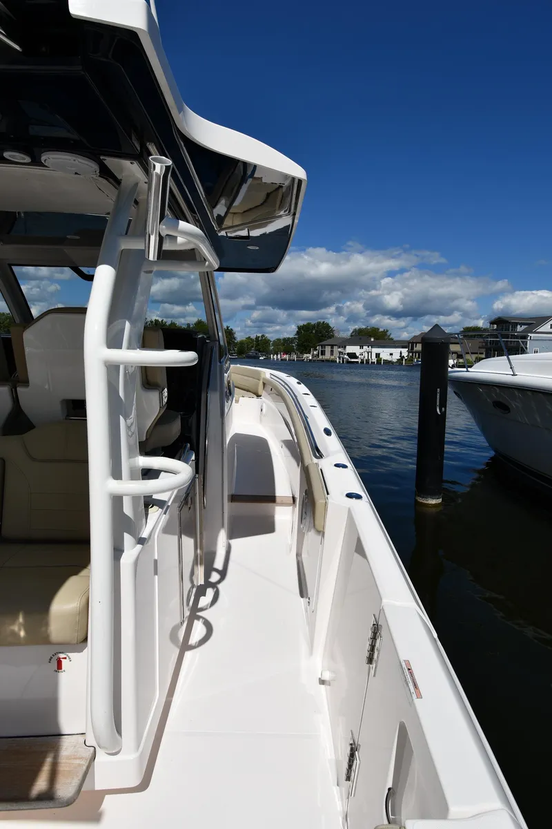 Slide: The Image of 2019 Pursuit S 408 Sport boat docked under clear blue sky. - 37