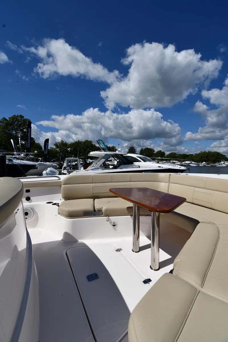 Slide: The Image of 2019 Pursuit S 408 Sport boat with seating area under a blue sky. - 44