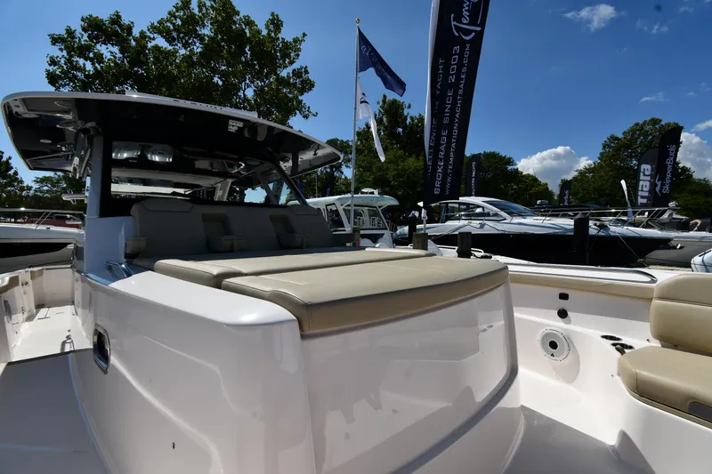 Slide: The Image of 2019 Pursuit S 408 Sport boat at a marina, showcasing sleek design and luxury seating. - 45
