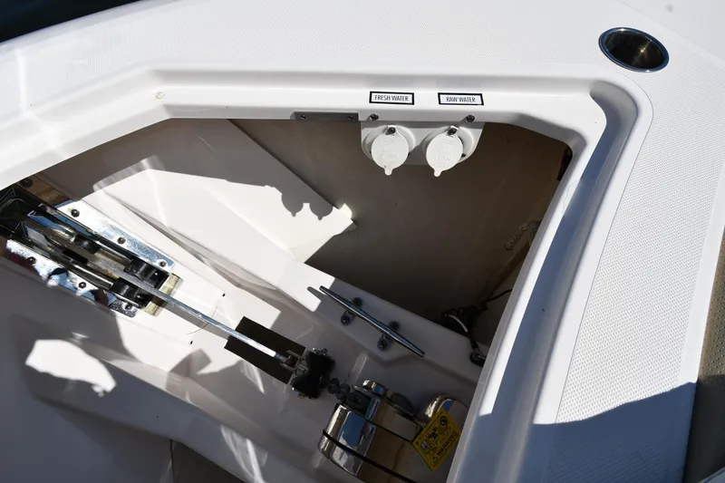 Slide: The Image of 2019 Pursuit S 408 Sport boat anchor compartment with winch and controls. - 5