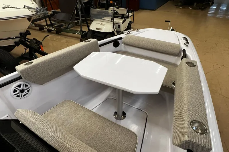 Slide: The Image of 2025 Axopar 22 Spyder interior with seating and table, showcasing modern design. - 13