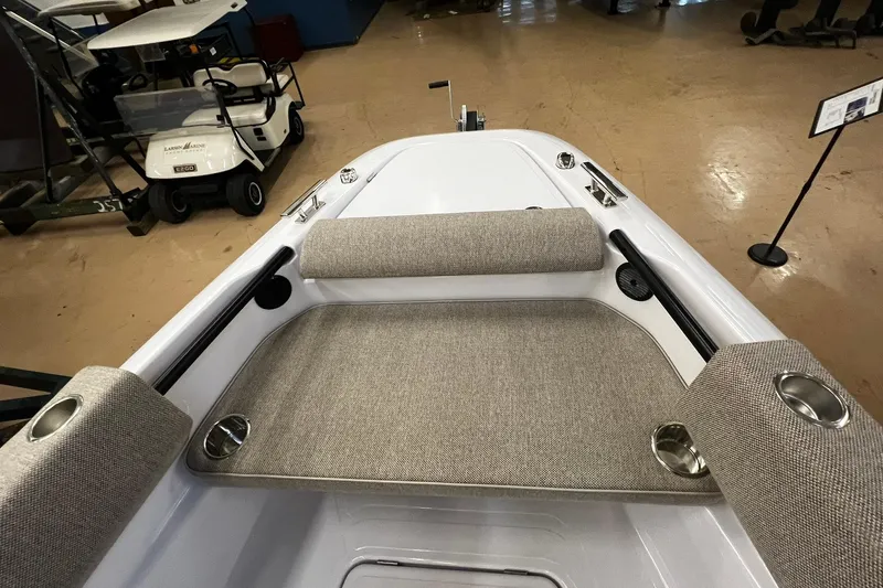 Slide: The Image of 2025 Axopar 22 Spyder boat interior with cushioned seating and cup holders. - 14