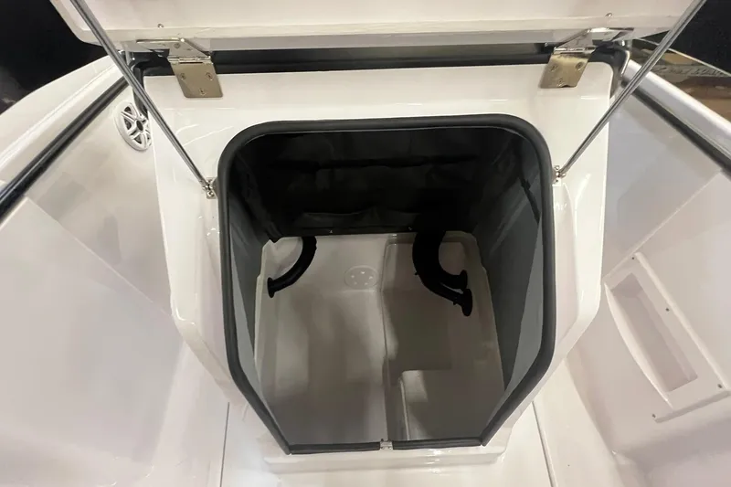 Slide: The Image of 2025 Axopar 22 Spyder storage compartment with open hatch, showcasing interior space. - 16