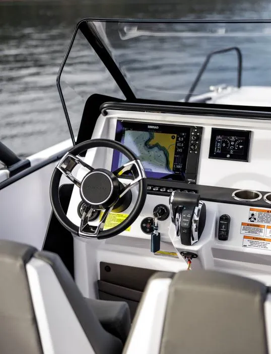 Slide: The Image of 2025 Axopar 22 Spyder interior with beige seating and a central table. - 4