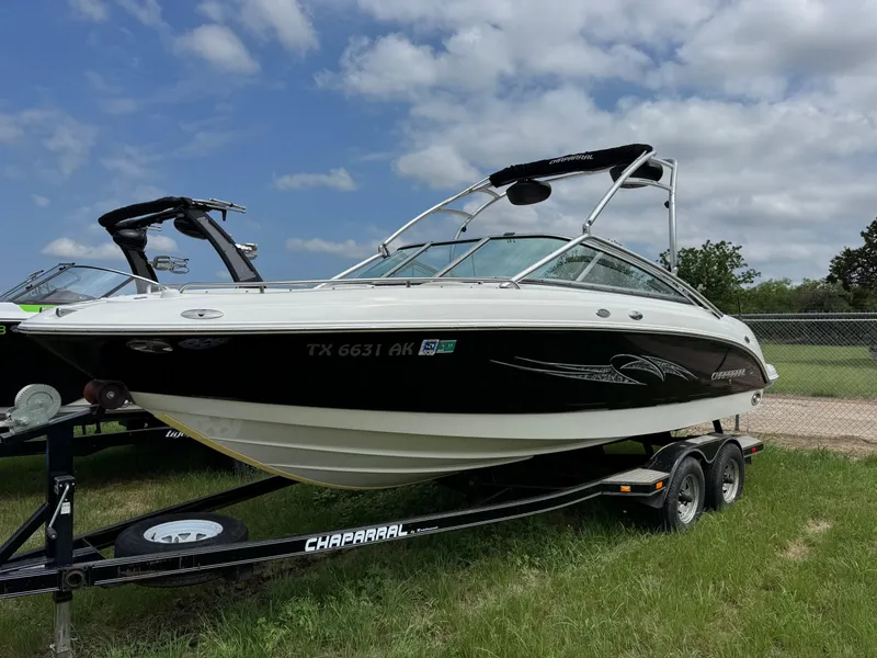 The Image of 2007 Chaparral 236 SSi boat on trailer, parked on grass under cloudy sky. - 0