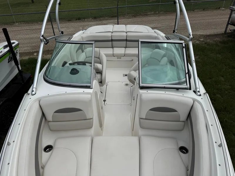 Slide: The Image of 2007 Chaparral 236 SSi boat interior with white seating and open windshield. - 14